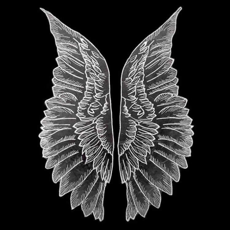 White organza wing appliques with embroidered leaf pattern on dark fabric