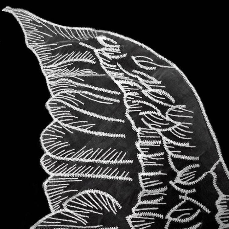 White embroidered leaf wing applique on organza, close-up detail