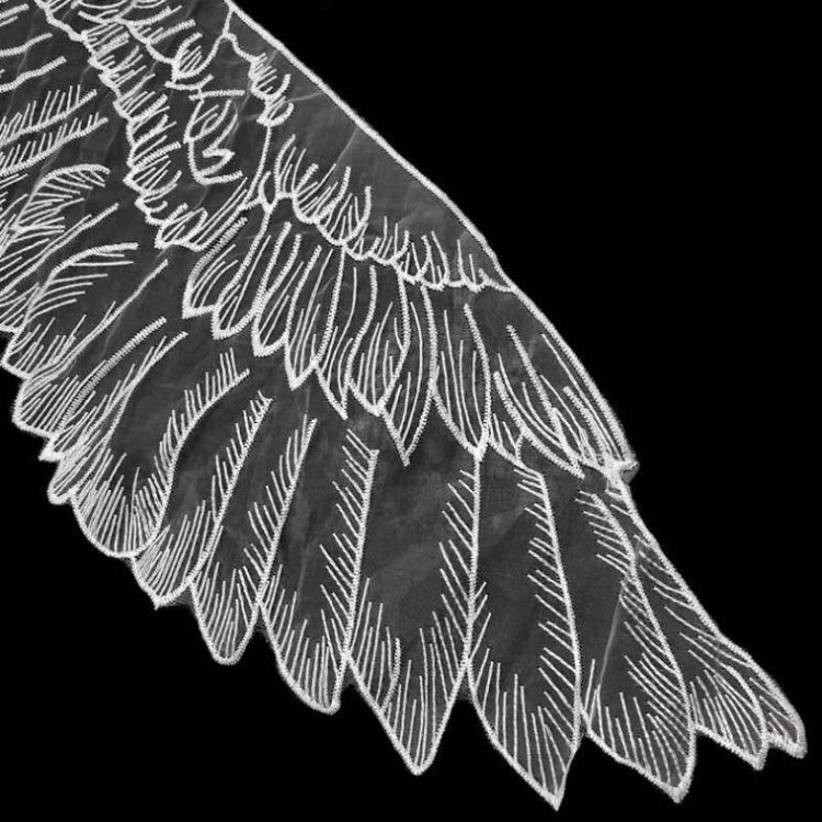 White organza wing applique with stitched feather lines, close-up