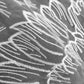 White thread embroidery on gray organza wing fabric, close-up