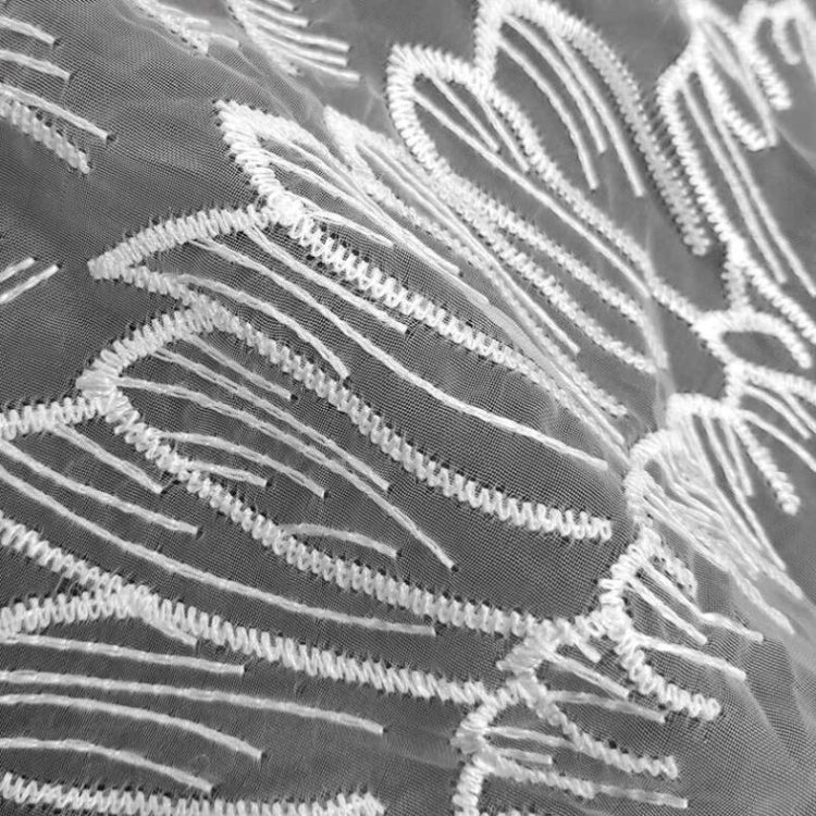 White thread embroidery on gray organza wing fabric, close-up