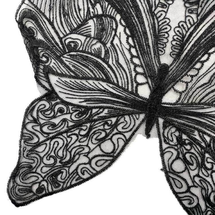 Close-up of butterfly lace collar embroidery in black and gray swirl details