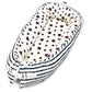 Baby nest bed with star print inner and navy chevron outer, white base and dark trim