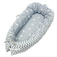 Baby nest bed with small star print inner and white chevron outer, gray-blue base with ties