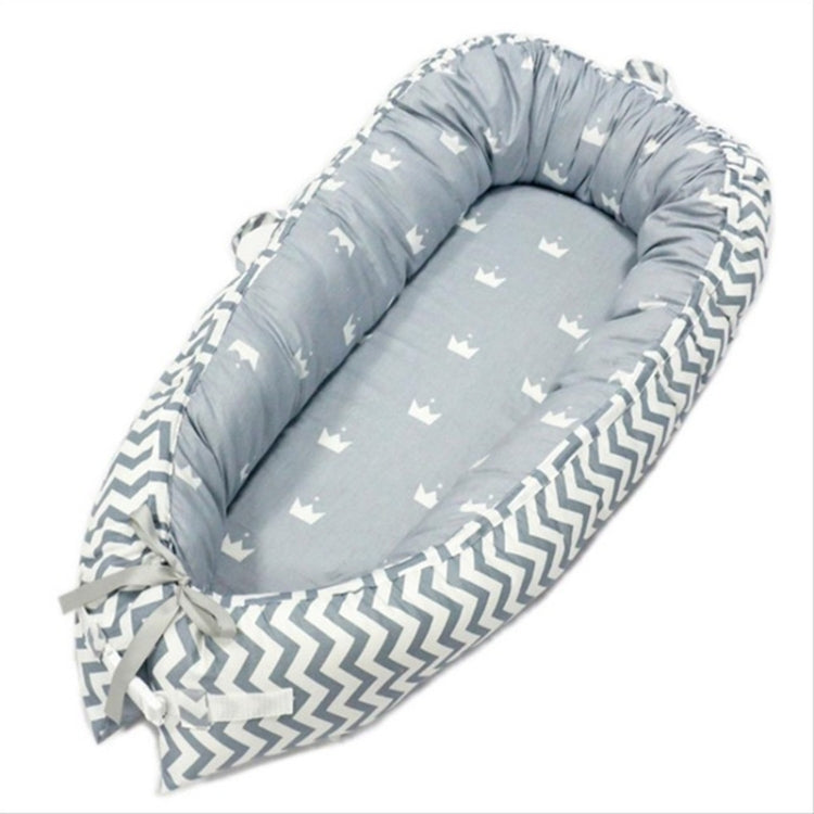 Baby nest bed with small star print inner and white chevron outer, gray-blue base with ties