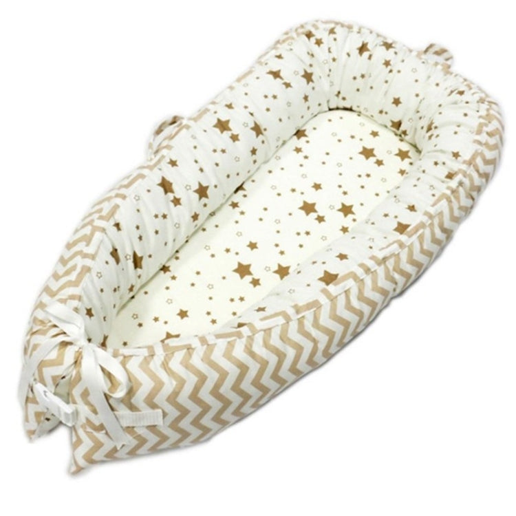 Baby nest bed with star print inner and tan chevron outer, cream base with bow ties