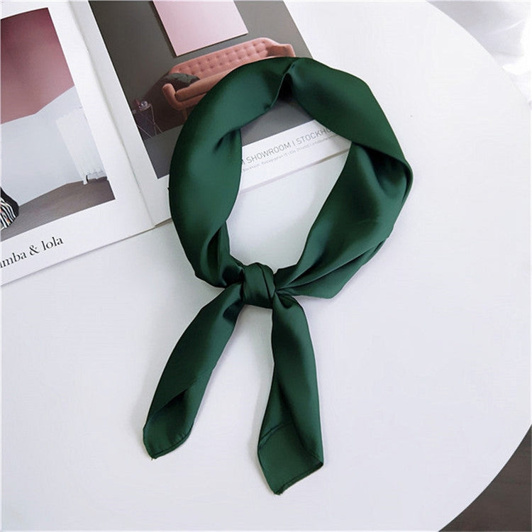 Dark green square satin scarf tied as a neck scarf with long bow ends