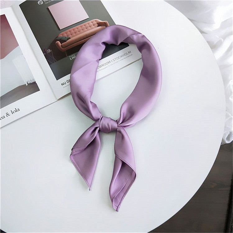 Purple square satin scarf tied as a neck scarf with long bow tails