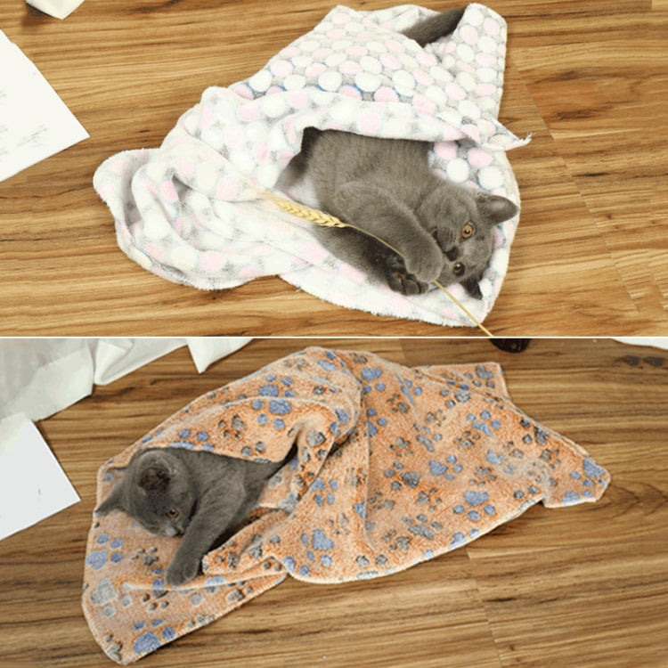 Pet flannel blanket, pastel dots, wrapped around cat on wooden floor