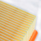 Close-up of yellow pleated filter media inside an orange filter frame