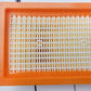 Orange plastic filter frame with white mesh grid, front view