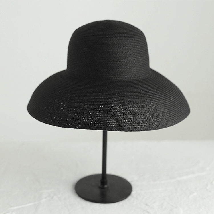 Black woven straw hat mannequin display, wide flared brim and rounded crown