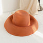 Orange woven straw sun hat with wide brim and smooth curved crown