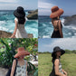 Set of straw sun hats on model in black and orange, wide brim and rounded crown