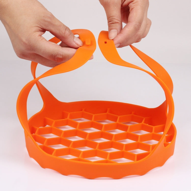 Orange silicone steamer egg cooker basket with raised egg tray and side handles