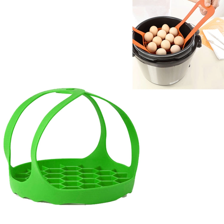 Green silicone steamer egg cooker basket with arched handle and raised egg tray