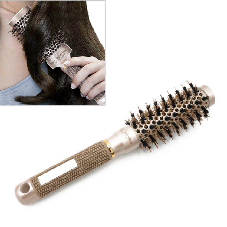 Round ceramic hair styling brush with nylon bristles and beige-gold handle, held near hair