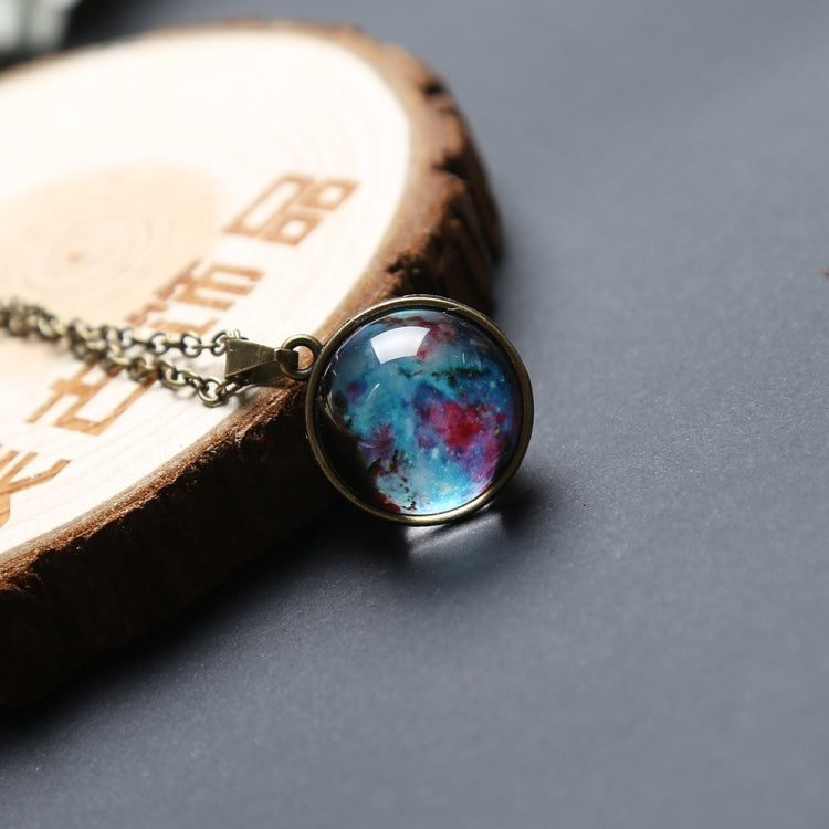 Round blue galaxy glass globe pendant in bronze bezel on chain