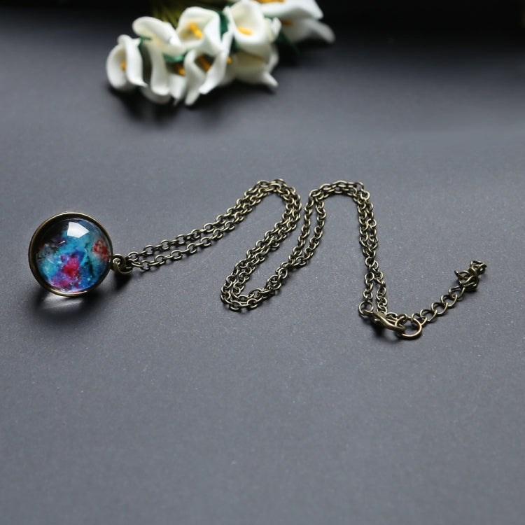 Gold-tone chain necklace with round galaxy glass globe pendant