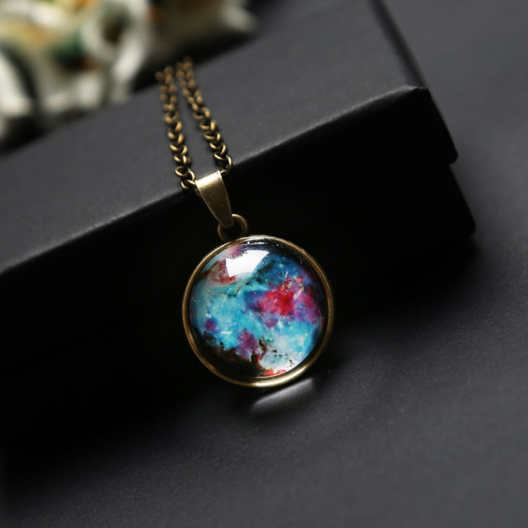 Round galaxy glass globe pendant on gold chain from a jewelry box