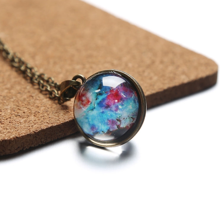 Round galaxy glass globe necklace pendant with bronze bezel on cork