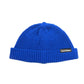 Blue knitted beanie hat with ribbed brim and pom top, one-size, branded label.