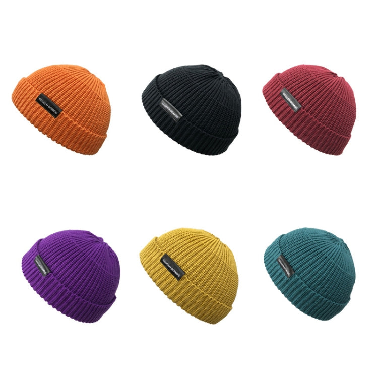 Assorted knitted beanie set: orange, black, red, purple, yellow, teal with pom tops.