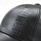 Black PU leather baseball cap with raised embossed front lettering.