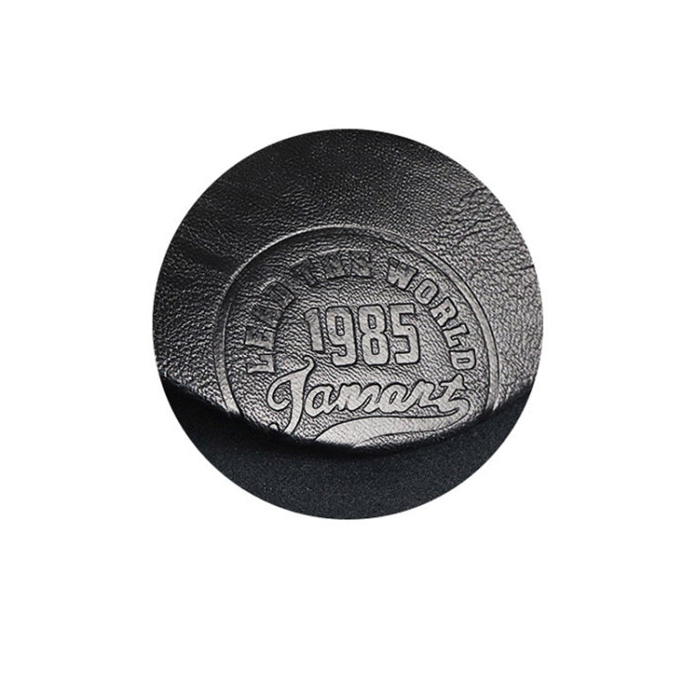 Black PU baseball cap top with embossed circular 1985 logo