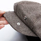 Octagonal snap beret hat close-up with metal snaps on the brim