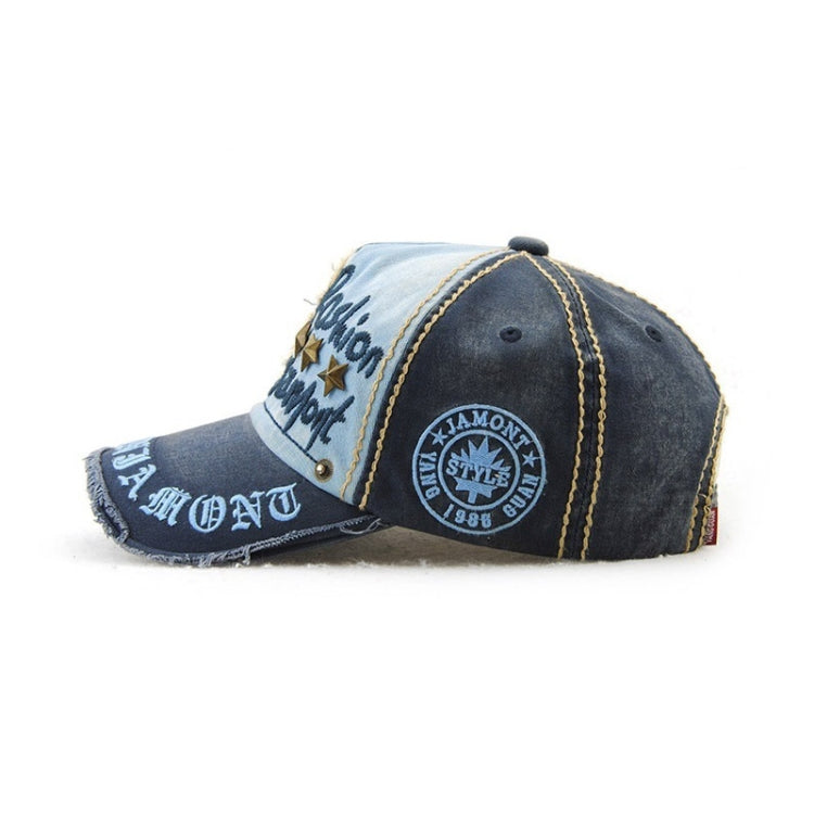 Casual baseball cap in navy with light blue panel, embroidered letters, and circular side patch.