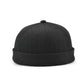 Black flanged landlord hat, top view with small button on crown.