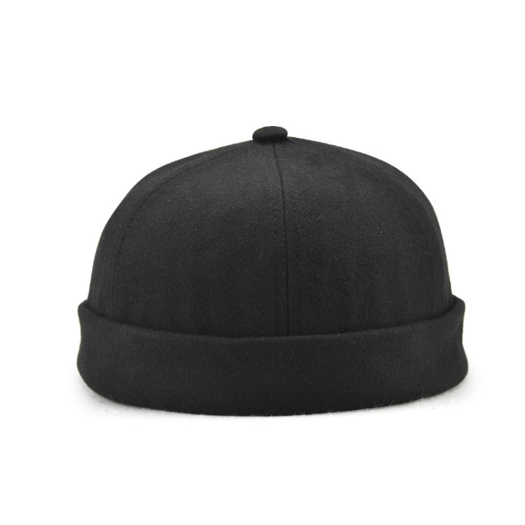 Black flanged landlord hat, top view with small button on crown.