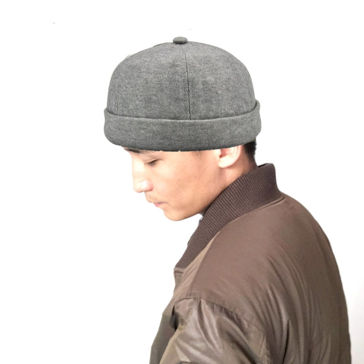 Grey retro flanged landlord hat worn by person, no eaves, rounded crown.