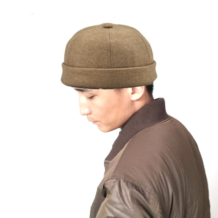 Deep beige retro flanged landlord hat worn by person, no eaves, rounded crown.