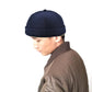 Dark blue retro flanged landlord hat worn by person, no eaves, rounded crown.