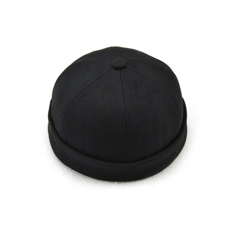 Black flanged landlord hat, top view with centered crown seam and button.
