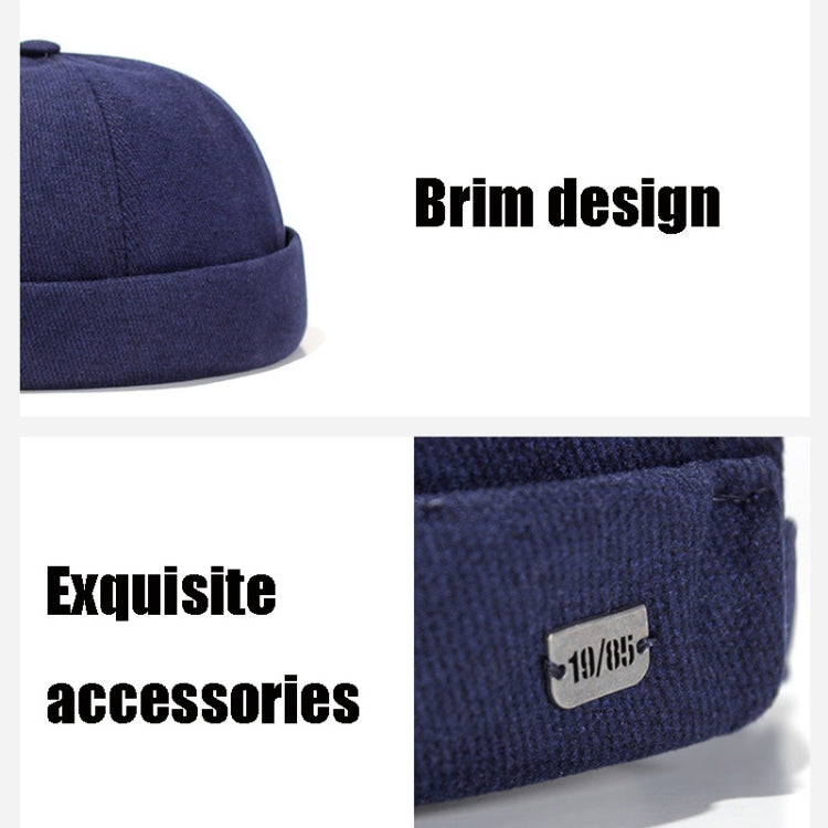 Navy flanged landlord hat with small fabric label patch on front brim.