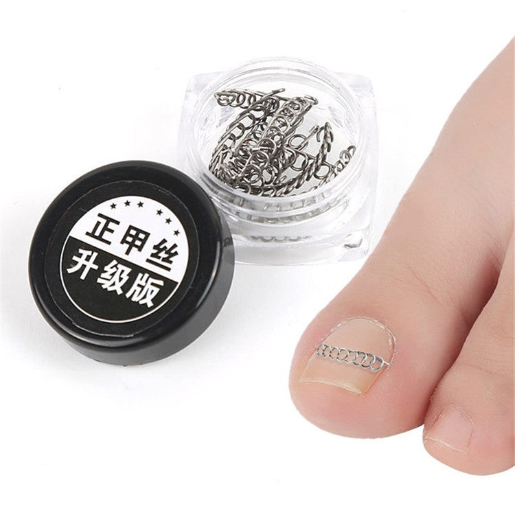 Close-up of a toe with a small silver spring toenail orthosis; metal clips container