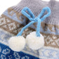 Pet knitted sweater detail, blue and brown pattern with bow and white pom-poms
