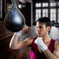 Hanging boxing speed ball, dark black pear with chain, textured surface, and strap