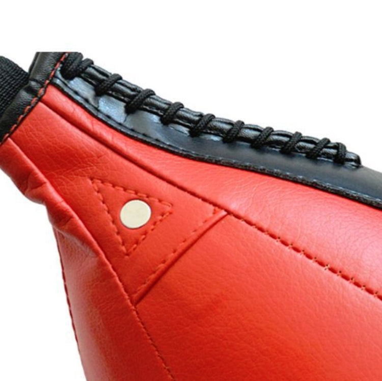 Boxing speed ball panel close-up, red leather with black trim and stitched seams