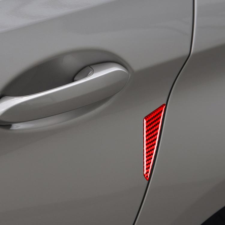 Red carbon fiber anti-collision sticker close-up on car door panel