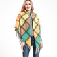 Fringed plaid square scarf in orange, tan, yellow, and teal with tassels