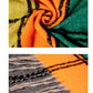 Plaid scarf fabric close-up, orange and teal stripes with fringed edge