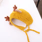 Yellow baby knitted antler hat with brown pom-pom ears and tie strings