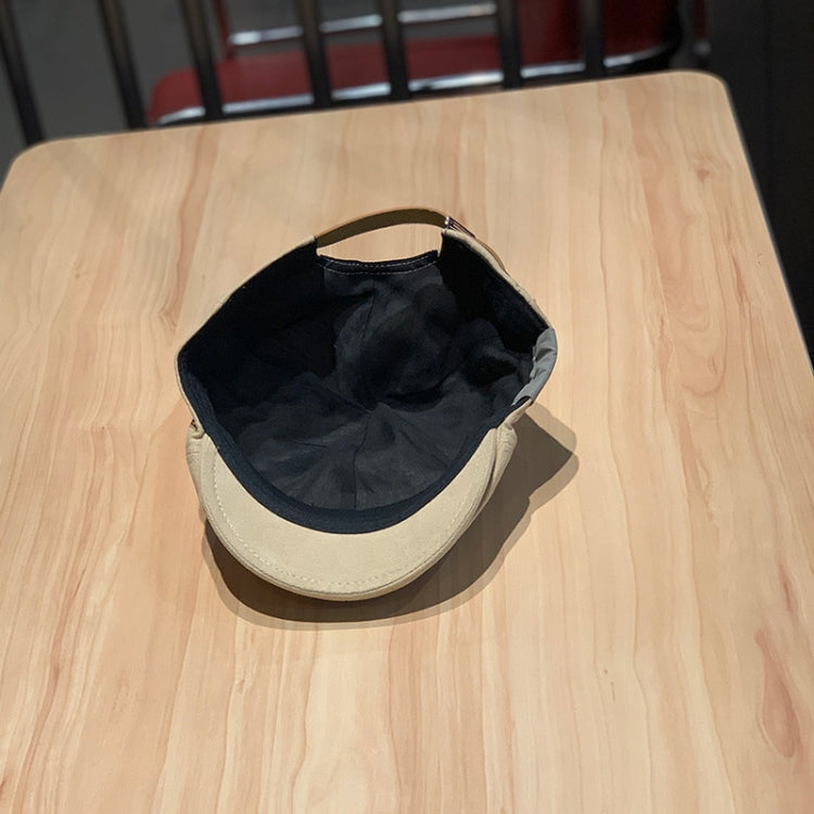 Two-tone newsboy cap inside view: black crown with cream brim and seams