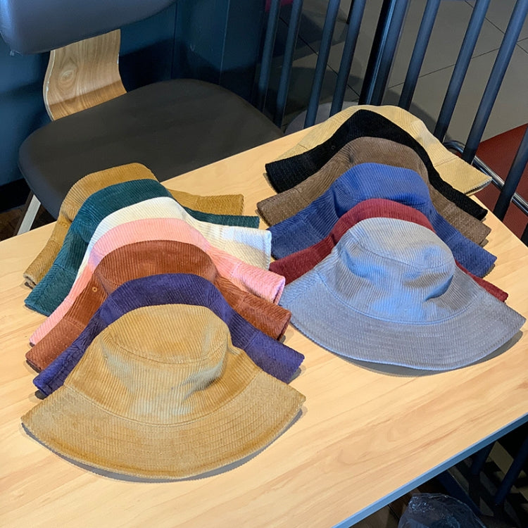 Assorted corduroy fisherman hats in multiple colors with short brims on a table