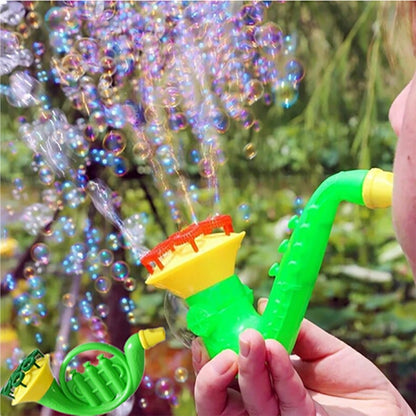 Green bubble blower toy with yellow parts, held in a hand as bubbles float