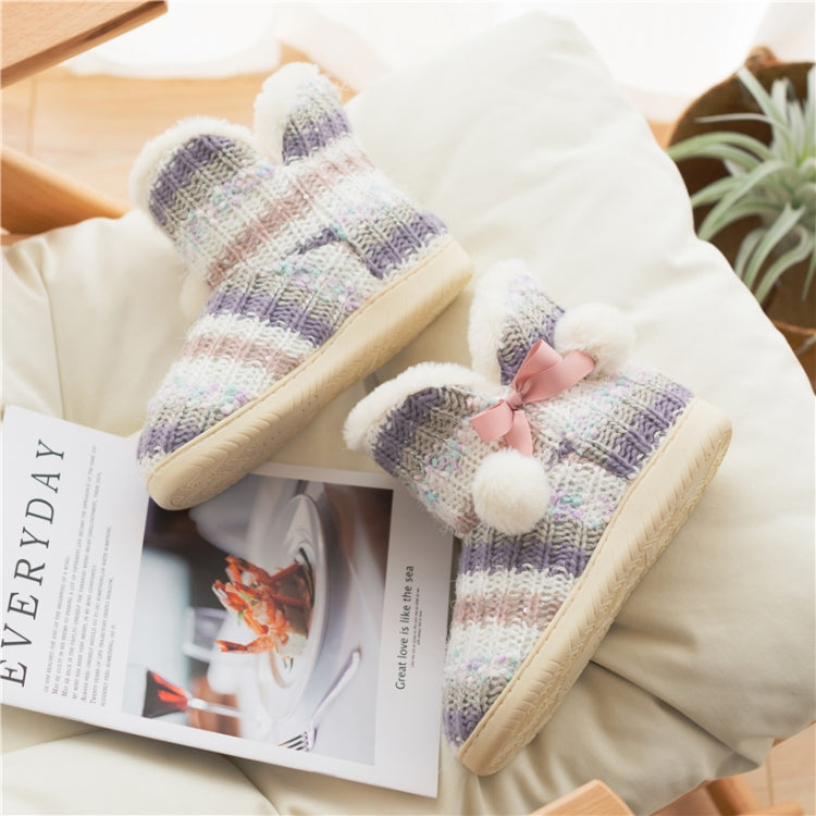 Two multicolor knit slippers with plush trim and pink bows, thick beige soles